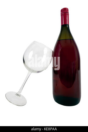 Red wine bottle with empty wine glass leaning against bottle. Isolated. Vertical. Stock Photo