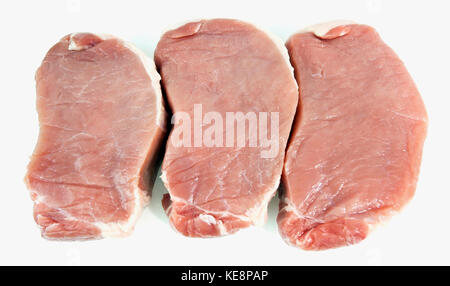 Three center cut pork chops. Isolated. Stock Photo
