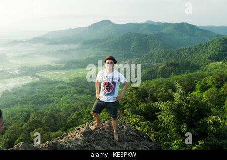 man poses with beautiful landscape on the background of him Stock Photo