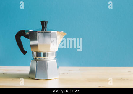 Italian metallic coffee maker Mocha coffee pot on wooden table Stock Photo