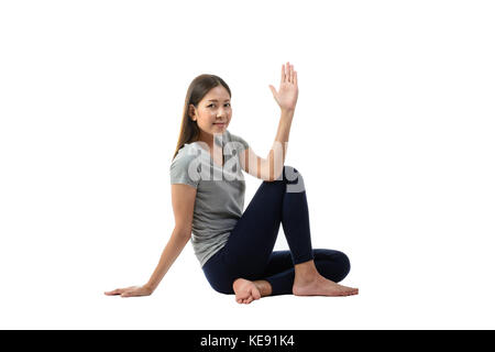 Young asian smiling woman practicing yoga, sitting in easy pose , healthy woman. Concept of healthy lifestyle and relaxation. Portrait isolalted,studi Stock Photo