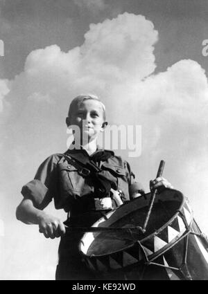 A boy, dressed in uniform, member of the National Socialist Hitler Youth, is beating his drum (undated picture). | usage worldwide Stock Photo