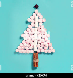 Fir tree silhouette from pink marshmallows on blue background Stock Photo