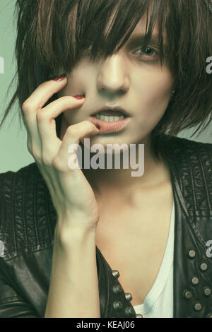 Androgyny female model in Heroin chic style. Old style tinted image Stock Photo