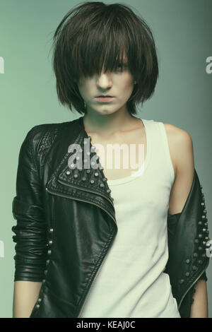 Androgyny female model in Heroin chic style. Old style tinted image Stock Photo