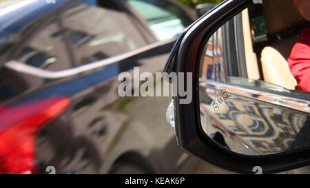 Autonomous cars on a road with visible connection. Blind Spot Monitoring system warning light icon in side view mirror of a modern vehicle. Car system Stock Photo