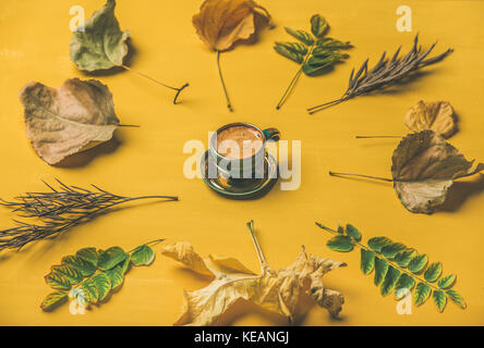 Flat-lay of espresso cup surrounded by dried fallen tree leaves Stock Photo