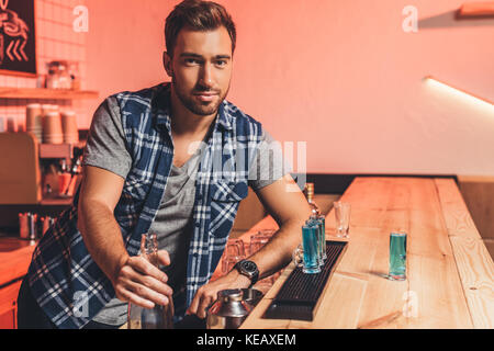 barman with alcohol shots on counter Stock Photo