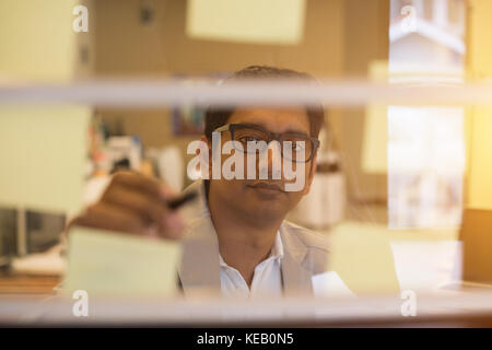 indian business male writing glass wall Stock Photo