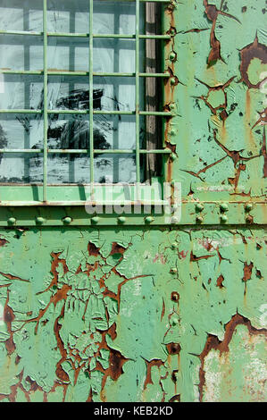 detail of window of old and rusty green iron trailer Stock Photo