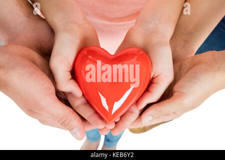 Close-up Of A Family Holding Red Heart Stock Photo
