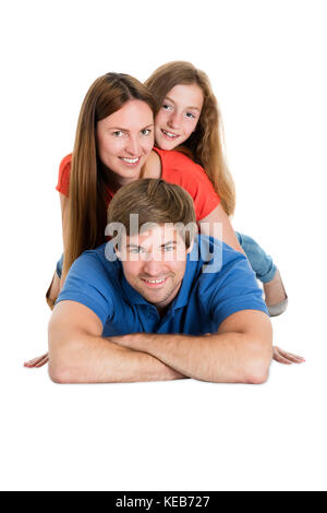 Family Lying On Top Of Each Other Isolated On White Background Stock Photo