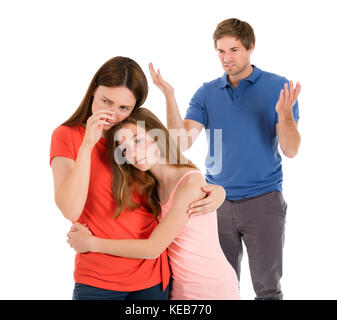 Daughter Comforting Mother While Her Parent Having Conflict Isolated On White Background Stock Photo