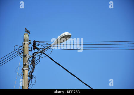 Lamp post with many cables that run in different directions Stock Photo