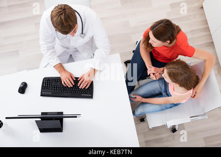 High Angle View Of A Doctor Having Discussion With Patient In Clinic Stock Photo
