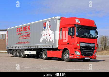 PAIMIO, FINLAND - APRIL 16, 2016: Red, new DAF XF Euro 6 semi truck and curtainsider trailer of Starek Transport parked at a truck stop in South of Fi Stock Photo