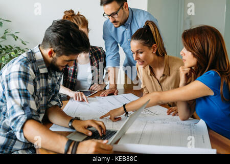 Image of business partners discussing documents and ideas Stock Photo