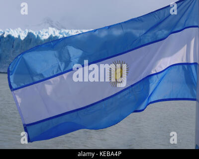 Argentina flag flying from mast on cruise ship on Lago Argentino, Perito Moreno Glacier Stock Photo