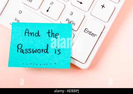 And the password is text on sticky note. with white computer keyboard. Stock Photo