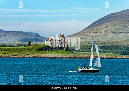 Sailing boat passes Duart Castle near Craignure on the Isle of Mull in Argyll & Bute western isles Scotland UK Stock Photo