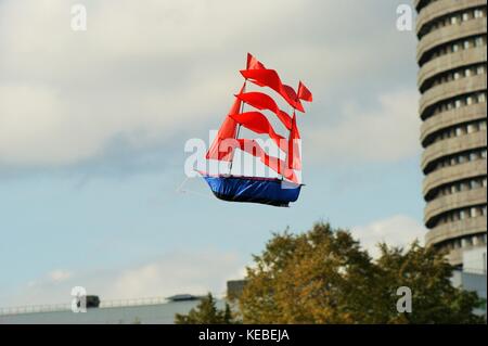 Sailboat sailing across the sky past the building-the personification of dreams Stock Photo