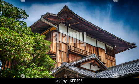 A traditional style Japanese wooden building with a tile roof Stock Photo