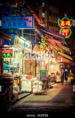 A laundry continues to work long after the market is closed for the night in Wan Chai, Hong Kong Stock Photo