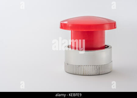 Big red button on light background - metaphor for 'Finger on the Button', possible finger on nuclear button, & concept of bringing things to a stop. Stock Photo