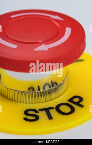 Big red button on light background - metaphor for 'Finger on the Button', possible finger on nuclear button, & concept of bringing things to a stop. Stock Photo