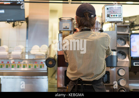 cook in a cafe preparing an order Stock Photo