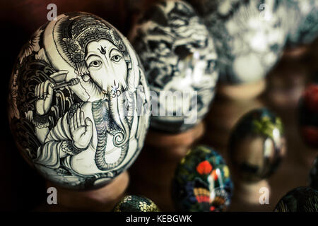 Artistically painted Ostrich eggs overshadow smaller chicken eggs which have all been decorated beautifully with Balinese Hindu Gods and Goddesses Stock Photo