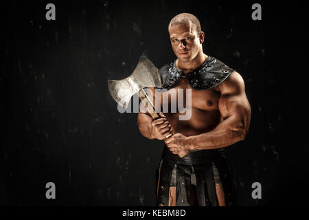 Severe barbarian in leather costume with hammer Stock Photo