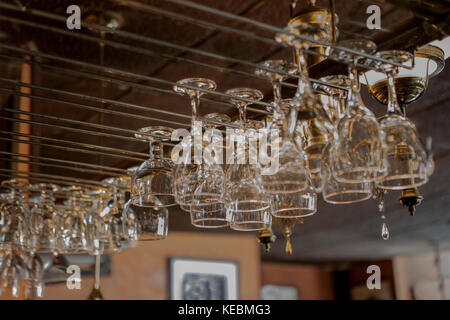 Bar Glasses Hanging from Rack Stock Photo