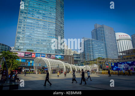 SHENZEN, CHINA - 29 JANUARY, 2017: Inner city streets and sorroundings of Nan Shan neighborhood, spectacular mix of green plants combined with modern buildings architecture, totally blue skies Stock Photo