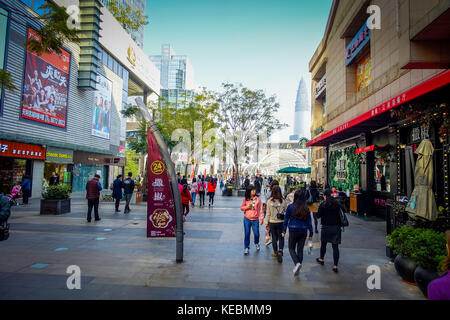 SHENZEN, CHINA - 29 JANUARY, 2017: Inner city streets and sorroundings of Nan Shan neighborhood, spectacular mix of green plants combined with modern buildings architecture, totally blue skies Stock Photo