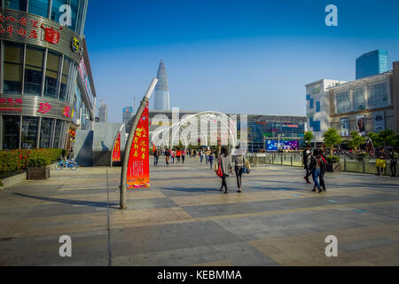 SHENZEN, CHINA - 29 JANUARY, 2017: Inner city streets and sorroundings of Nan Shan neighborhood, spectacular mix of green plants combined with modern buildings architecture, totally blue skies Stock Photo