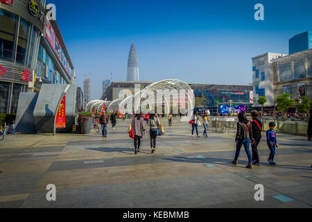 SHENZEN, CHINA - 29 JANUARY, 2017: Inner city streets and sorroundings of Nan Shan neighborhood, spectacular mix of green plants combined with modern buildings architecture, totally blue skies Stock Photo