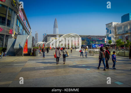 SHENZEN, CHINA - 29 JANUARY, 2017: Inner city streets and sorroundings of Nan Shan neighborhood, spectacular mix of green plants combined with modern buildings architecture, totally blue skies Stock Photo