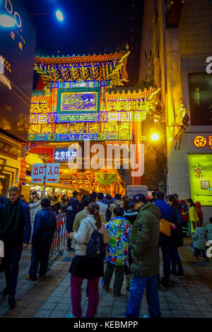 BEIJING, CHINA - 29 JANUARY, 2017: People walking around charming streets with small restaurants, traditional architecture and decorations, local Donghuamen food market concept Stock Photo