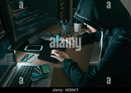 high angle view photo of hacker using computer online system stolen brushing credit card. Stock Photo