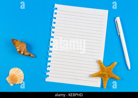 Page ripped off from the notebook, seashells and starfish on blue background. Vacation, travel concept Stock Photo