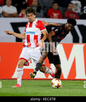 Belgrade. 20th Oct, 2017. Crvena Zvezda's Filip Stojkovic (L) vies with Arsenal's Ainsley Maitland-Niles during UEFA Europa League match between Crvena Zvezda and Arsenal in Belgrade, Serbia on Oct 19. 2017. Arsenal won 1-0. Credit: Predrag Milosavljevic/Xinhua/Alamy Live News Stock Photo