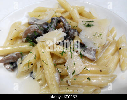 Plate with italian pasta with green herb Stock Photo