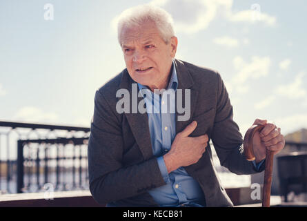 Senior man suffering from severe angina Stock Photo