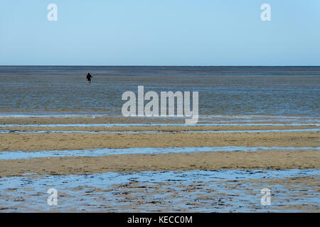 A lone beach fisherman standing in the Indian Ocean, Bush Bay, The Gascoyne, Western Australia Stock Photo