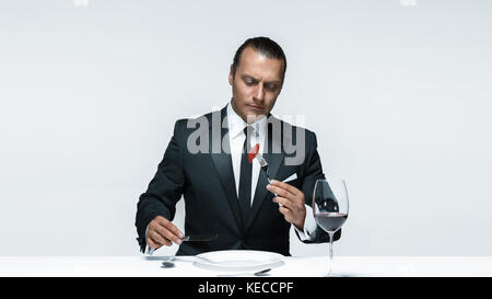 Bloody Halloween theme: crazy man with a knife, fork and meat Stock Photo