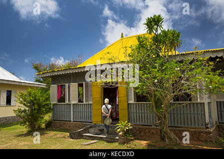 The Seychelles, Mahe, Anse aux Pins, St Roche Au Cap, Domaine Val des Pres Estate cultural village, tourist entering craft workshop Stock Photo