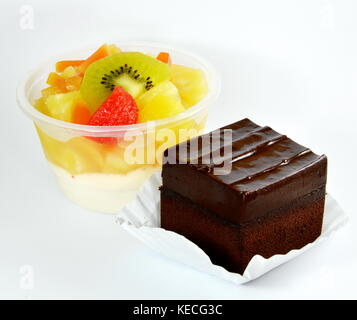 chocolate cake and fruit salad on white background Stock Photo