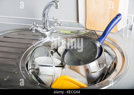 A lot of dirty dishes in kitchen sink Stock Photo