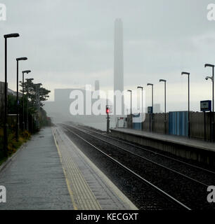 Wet day on Downshire railway station, Kilroot power station in distance Stock Photo